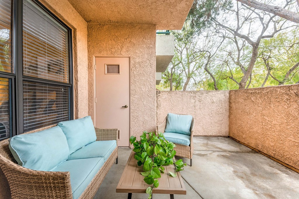 a patio with two chairs and a table