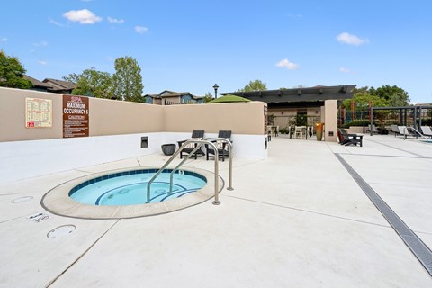 A small pool in a concrete patio with a sign that says "maintenance occupancy".