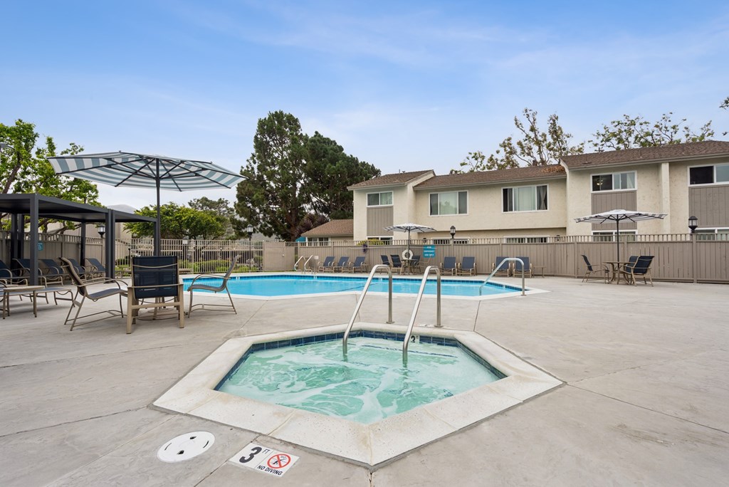 A pool with a hot tub in the middle of it.