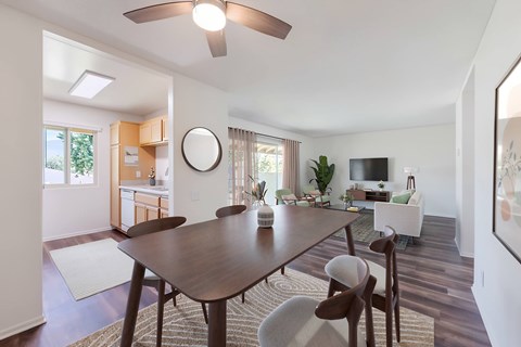A modern dining room with a wooden table and chairs.