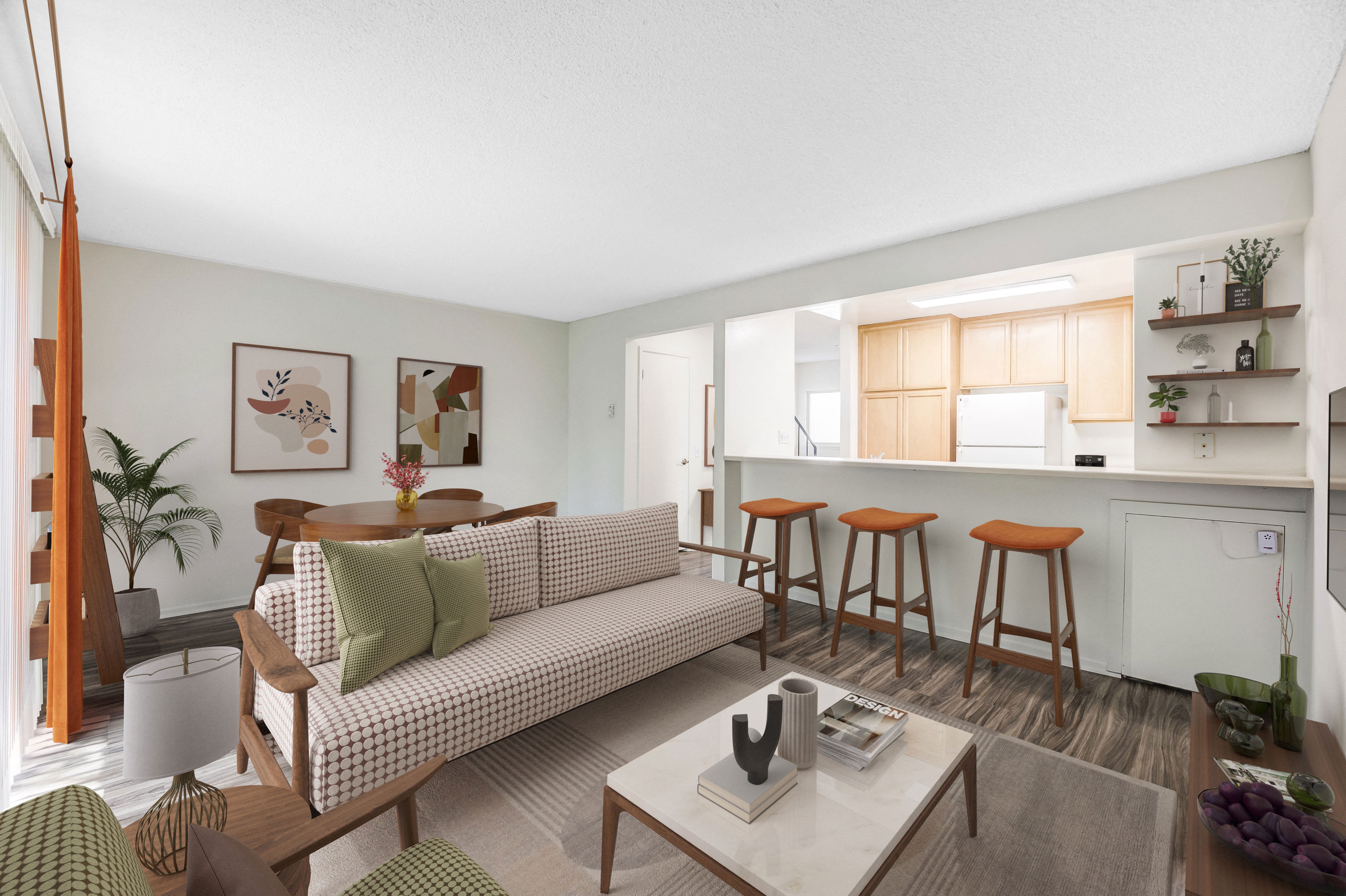 a living room with a couch and a kitchen with a bar