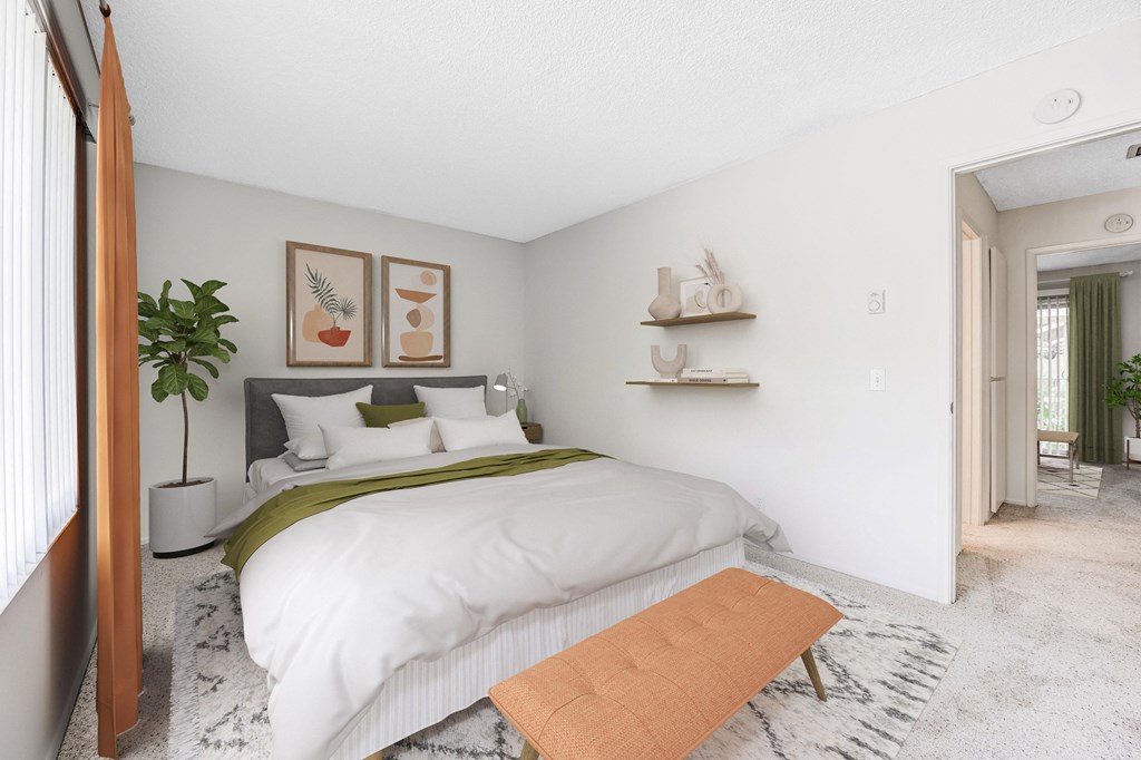 a bedroom with a white bedspread and green blanket