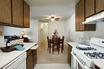 Orcutt, CA Apartments- Knollwood Meadows- Wood-Style Cabinets With Tile Floors and Spacious Countertops - Photo Gallery 4
