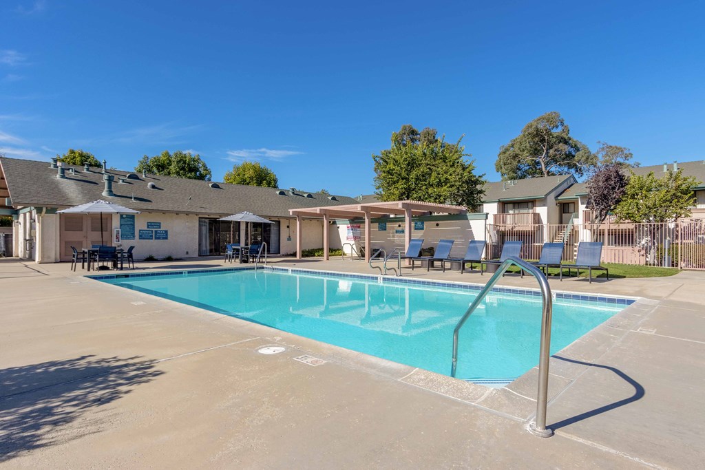Pet-Friendly Apartments in Orcutt, CA - Knollwood Meadows - Sparkling Pool With Lounge Seats, Tables and Chairs with Umbrellas, Pergola, and Hot Tub