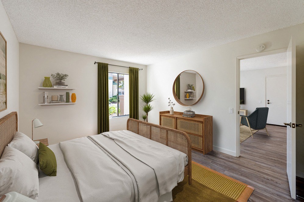 a bedroom with a bed and a mirror on the wall