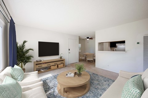 A living room with a white couch and a wooden coffee table.
