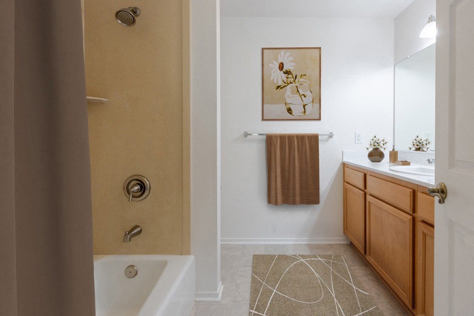a bathroom with a shower and a sink and a mirror