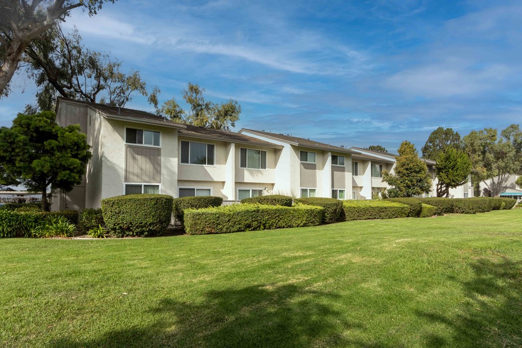 the apartments are located in a complex with a green lawn