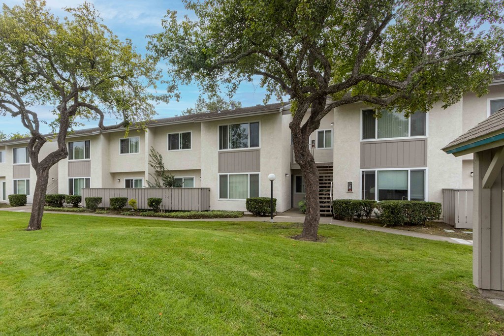 Apartments for Rent in Lompoc, CA - Oceanwood - Courtyard with Lush Grass, Bright Skies, and View of Apartment Complex