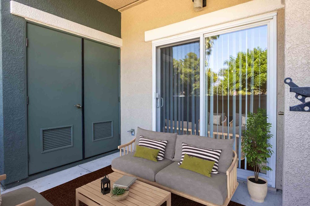 a patio with a couch and a patio door
