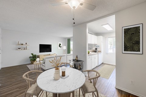 A dining room with a white table and chairs.