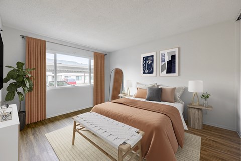A bedroom with a bed, nightstand, and window.