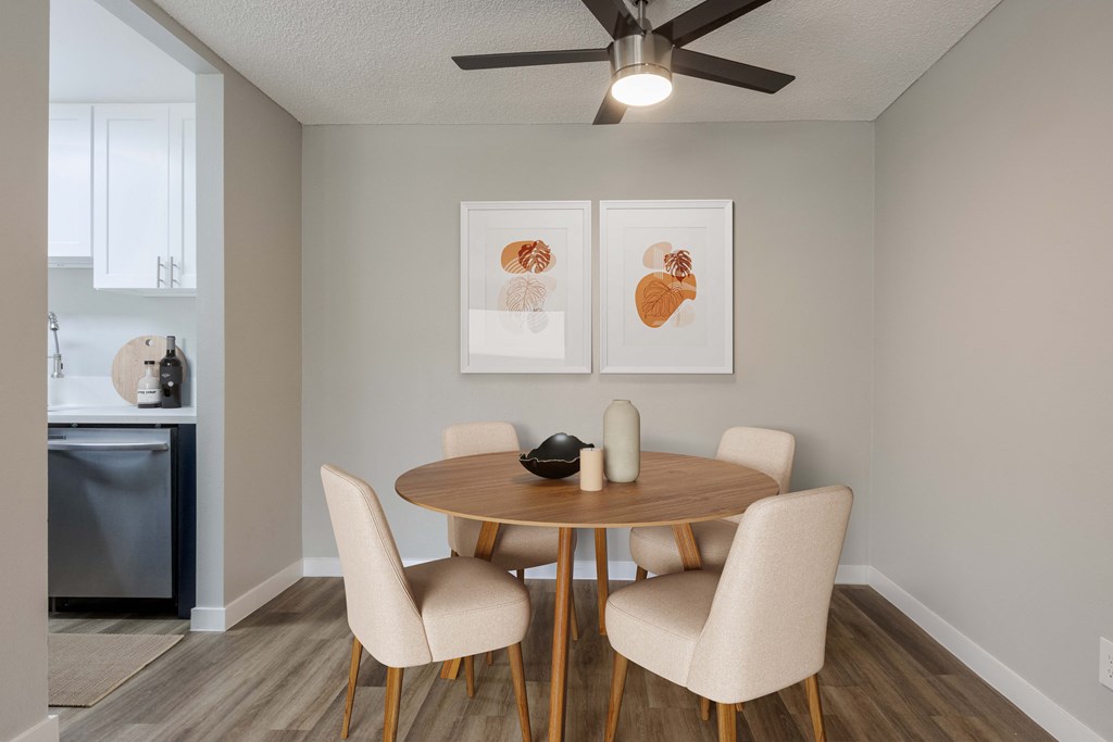 a dining room with a table and chairs and a ceiling fan