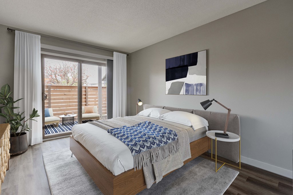 a bedroom with a large bed and a large window