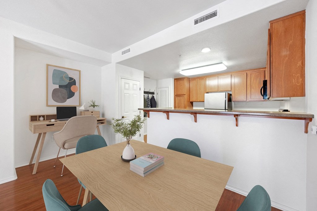 a dining room and kitchen with a table and chairs