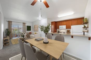 a living room and dining room with a table and chairs