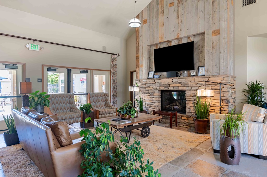 a living room with couches a coffee table and a fireplace
