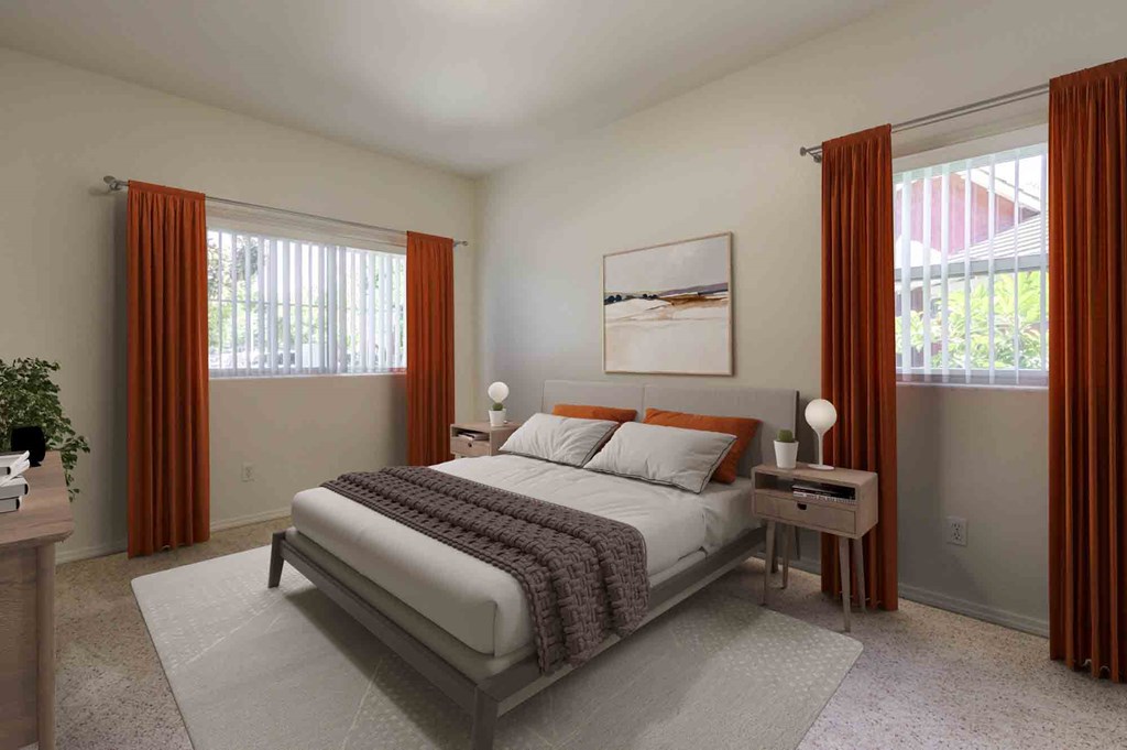 Dog-Friendly Apartments in Goleta, CA - Sumida Gardens - Bedroom with Plush Carpeting, Large Bed, Nightstands with Lamps, Wall Art, and Windows.