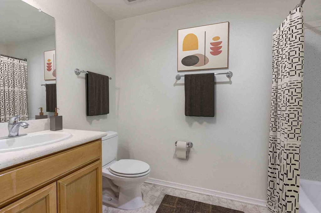 a bathroom with a toilet and a sink and a shower