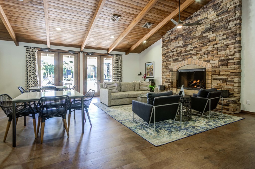 a living room with a fireplace and a dining table