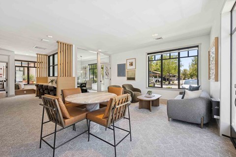 A modern dining room with a large table and chairs.