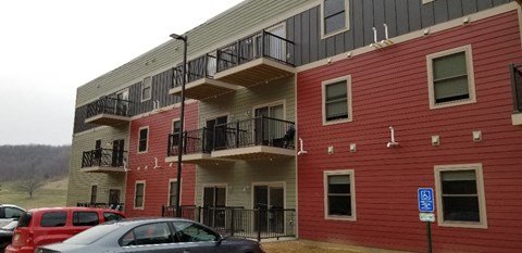 A red building with a blue sign in front of it.