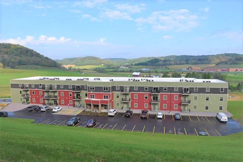 A large building with a parking lot in front of it.