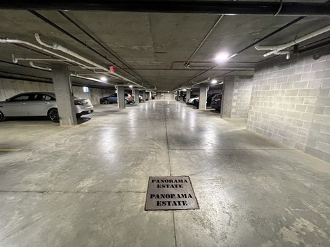 A parking garage with a sign that says "PENOBAMA STATE" on the floor.