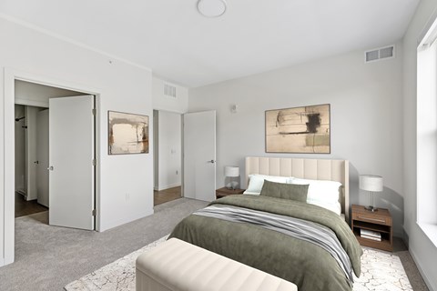 A bedroom with a large bed and a painting on the wall.