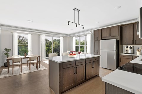 A kitchen with a table and chairs in front of a window.