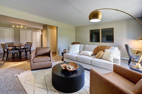 A living room with a white couch and a coffee table.