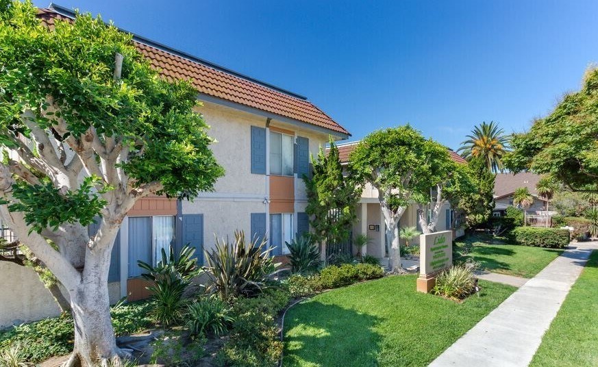 A house with a tree in front of it.