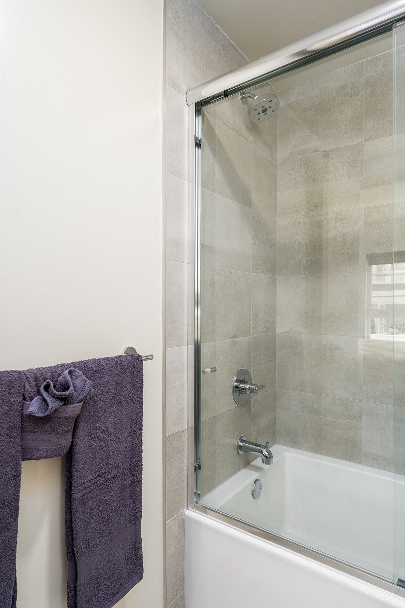 a bathroom with a shower and a bath tub and a towel at Lido Apartments - 1532 Brockton Ave, Los Angeles, 90025