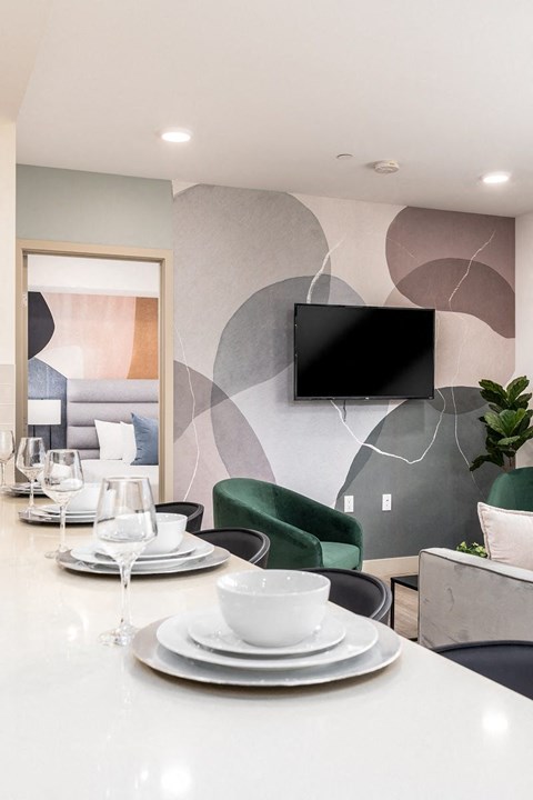 Modern dining area with abstract wall mural at Lido - 1532 Brockton Ave Apartments, California