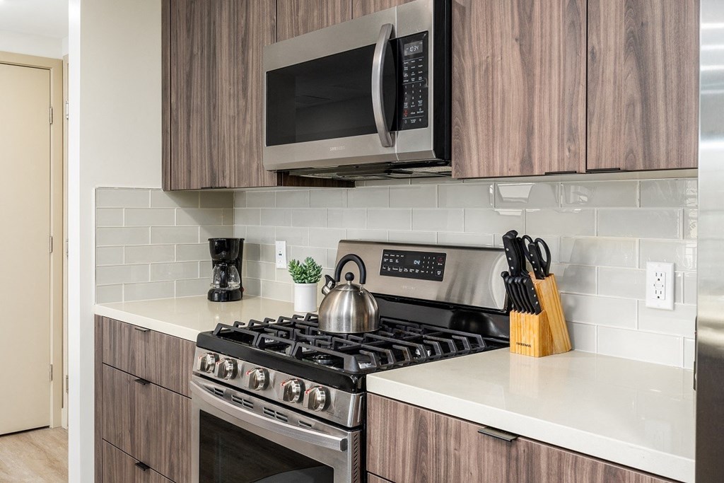 a kitchen with a stove and a microwave at Lido Apartments - 1532 Brockton Ave, Los Angeles, CA