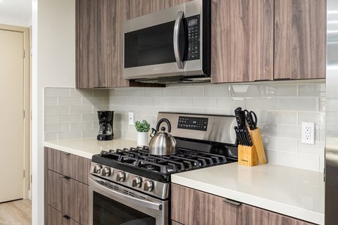 a kitchen with a stove and a microwave