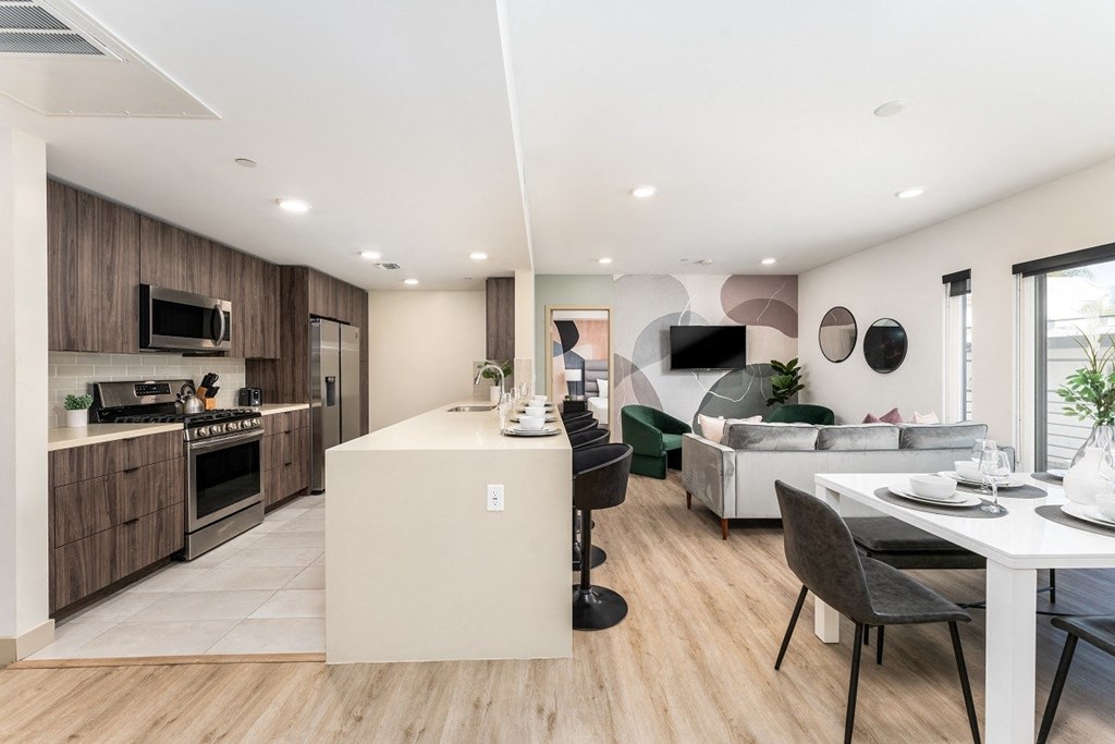 a kitchen and living room with a table and chairs at Lido Apartments - 1532 Brockton Ave, Los Angeles, CA, 90025