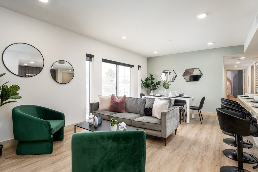 a living room with a couch and chairs and a dining room table at Lido Apartments - 1532 Brockton Ave, California, 90025