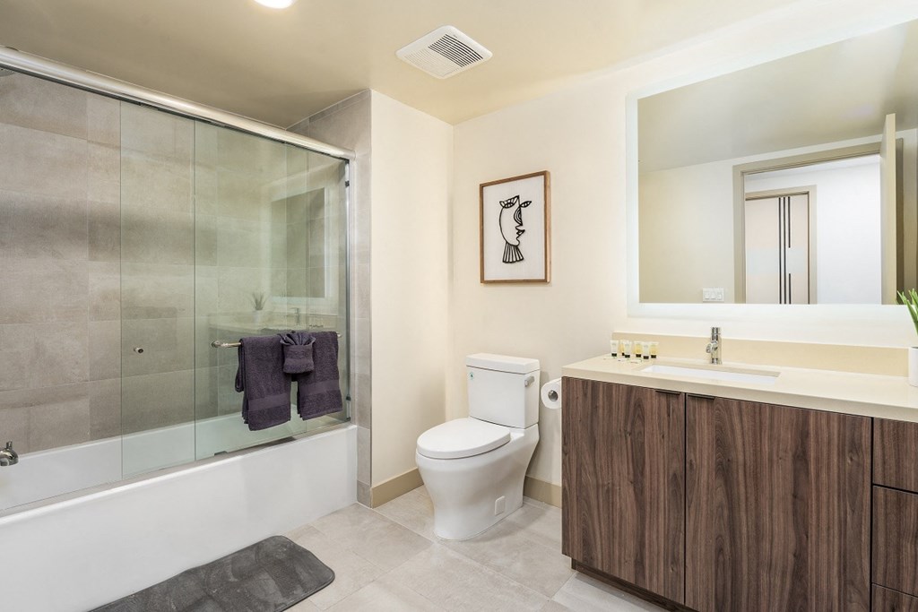 a bathroom with a shower toilet and a sink at Lido Apartments - 1532 Brockton Ave, California