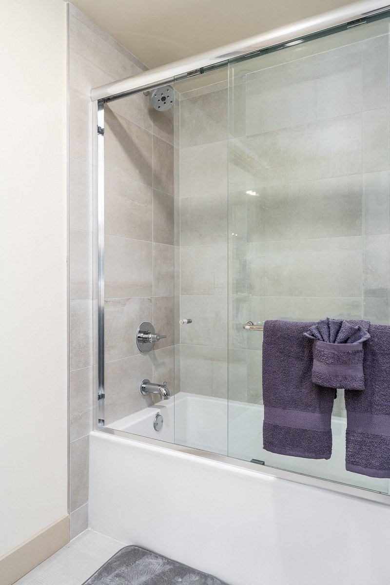 a shower with a glass door in a bathroom at Lido Apartments - 1532 Brockton Ave, California, 90025