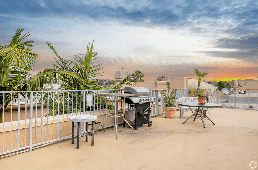 the patio has a bbq grill and a table and chairs
