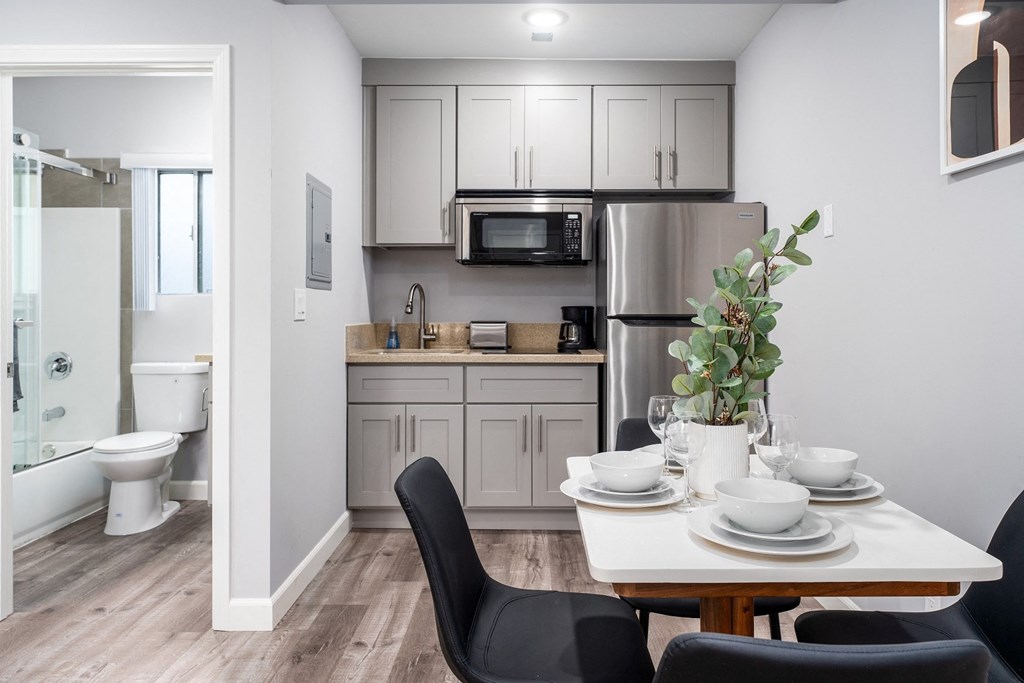 a kitchen and dining room with a table and chairs