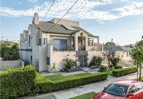 a house with a red car parked in front of it