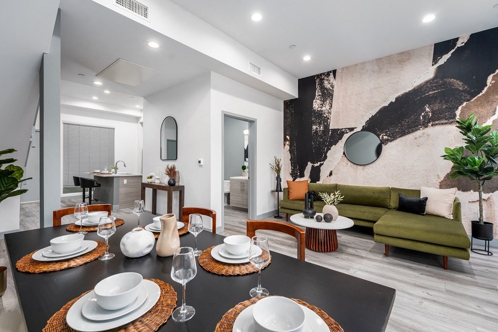 a dining room with a table and chairs and a living room at Lido Apartments - 4025 Grandview, Culver City, CA, 90066