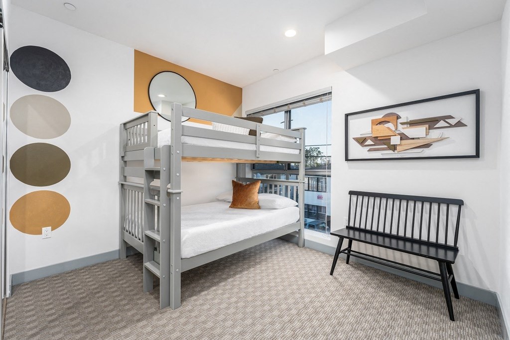 a bunk bed in a bedroom with a window at Lido Apartments - 4025 Grandview, California