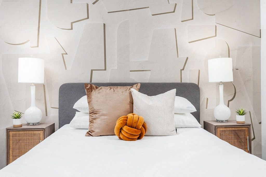 a bedroom with a large bed with white sheets and pillows at Lido Apartments - 4025 Grandview, California, 90066