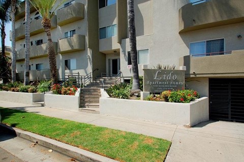 Apartment complex named Lido with a green lawn in front.
