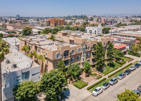 A residential area with apartment buildings and parked cars.