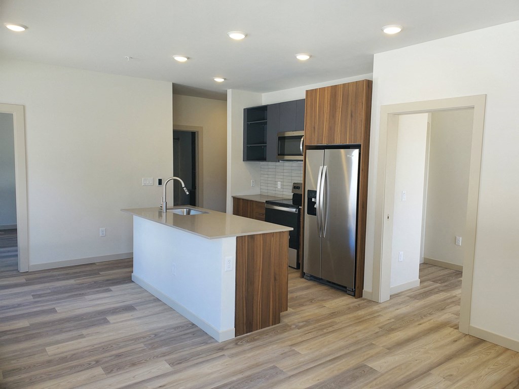 a kitchen with a large island and a stainless steel refrigerator  at Lido Apartment Homes @ Hailey, ID, Hailey, ID 83333