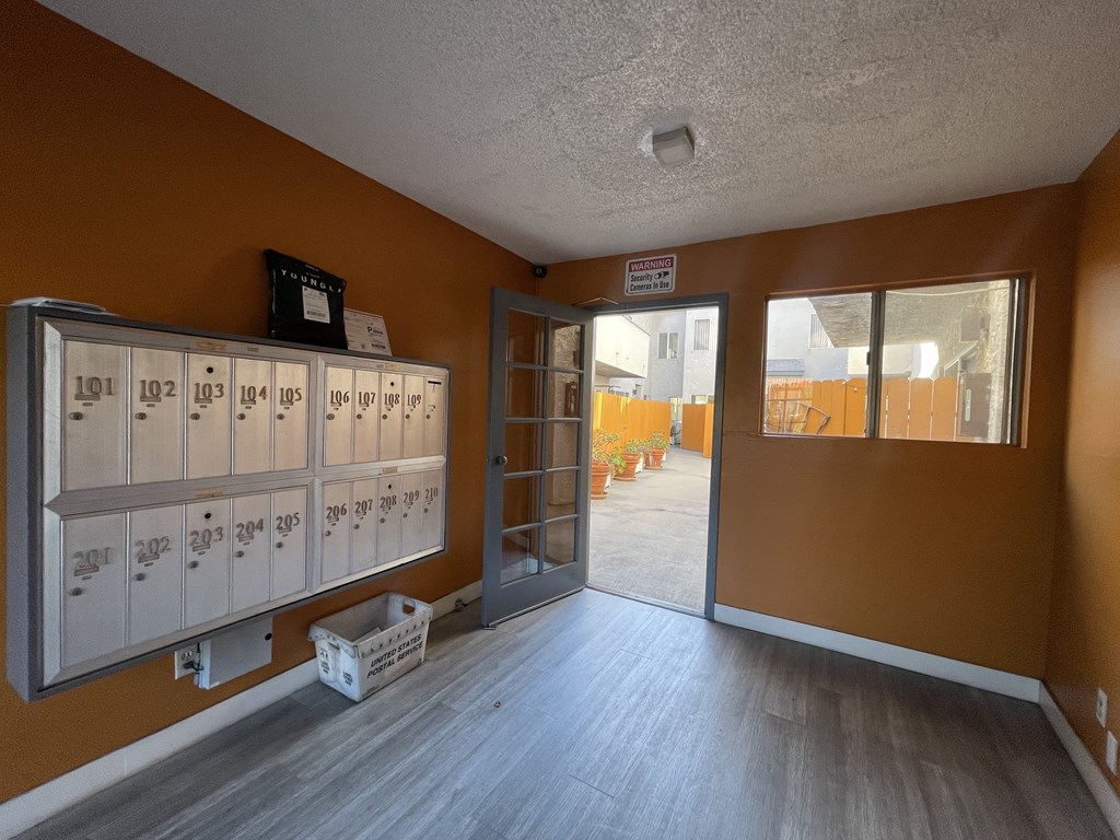 A storage room with numbered lockers and a sign on the wall.
